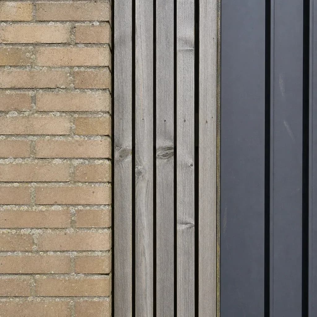 Close view where brick, vertical timber boarding and standing-seam metal meet on one exterior wall